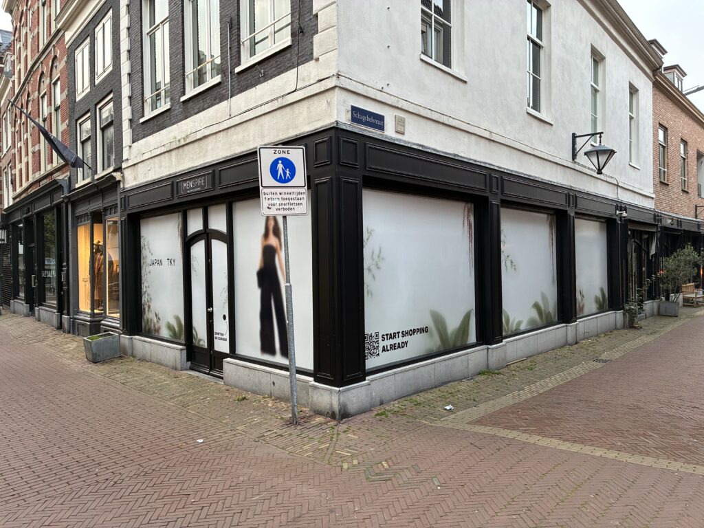 Tijdelijke raambelettering bij Japan TKY in Haarlem, met bedrukte etalageruiten aan beide zijden van het winkelpand.